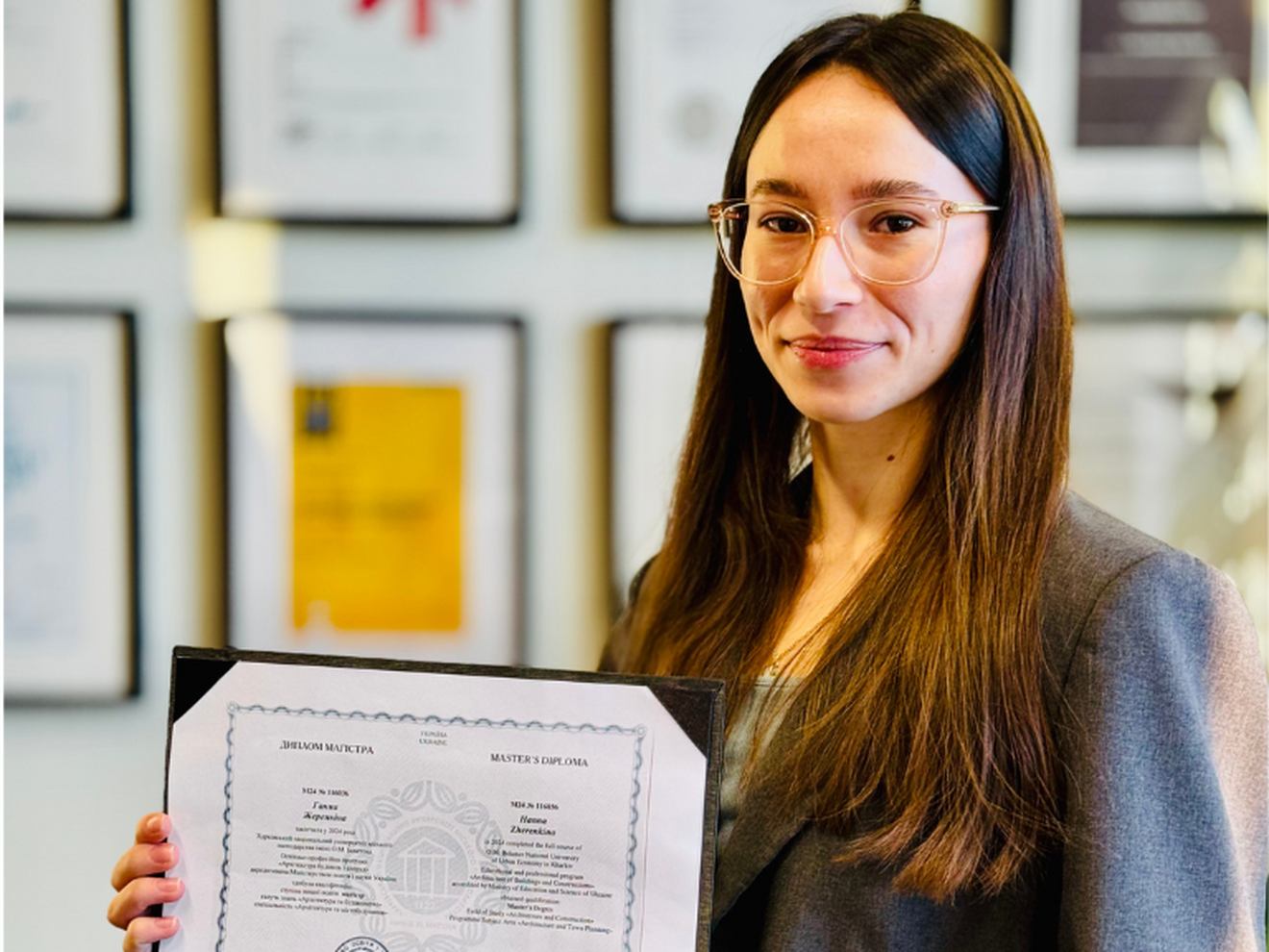 Hanna Zherenkina holder opp diplomet sitt. Foto: Bjørnådal Arkitektstudio